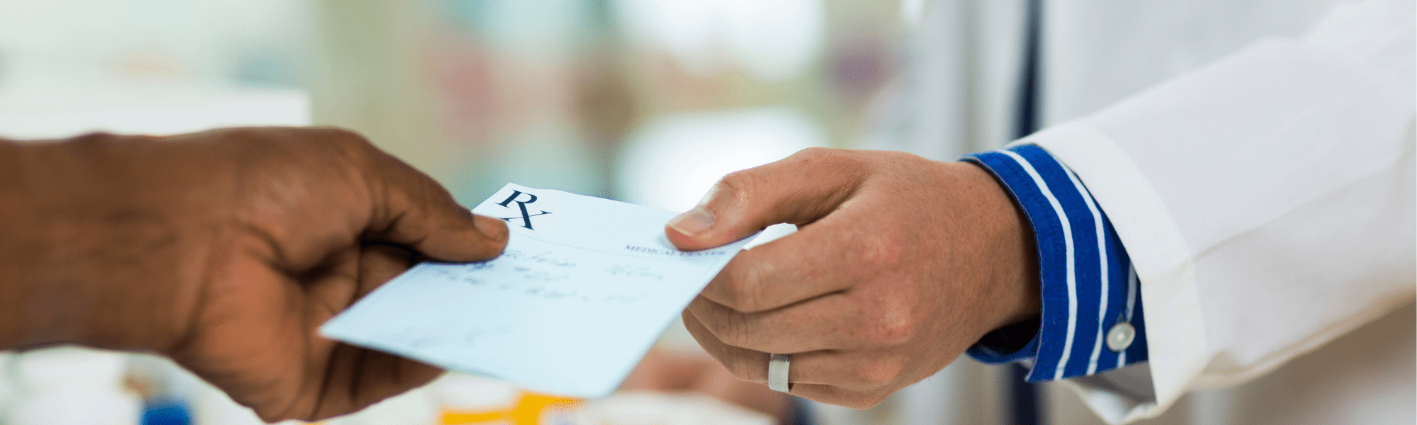 pharmacist handing prescription slip to customer 