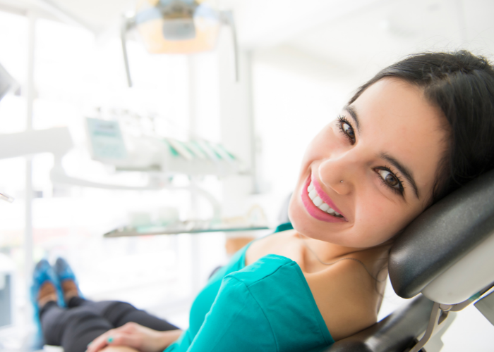 woman smiling in a dentist chair 